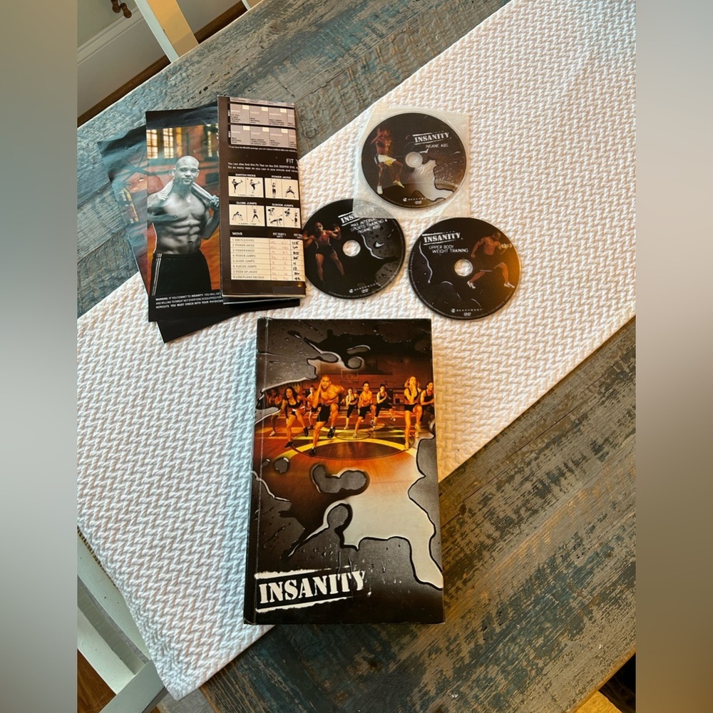 Insanity DVDs set (13 workouts) Great used condition, glue failed at front cover